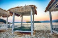 Thatched canopies and awnings on the beach Copacabana at sunset in Dubrovnik Royalty Free Stock Photo