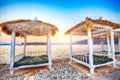 Thatched canopies and awnings on the beach Copacabana at sunset in Dubrovnik Royalty Free Stock Photo