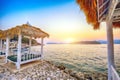 Thatched canopies and awnings on the beach Copacabana at sunset in Dubrovnik Royalty Free Stock Photo