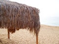 Thatched canopy on the empty sea beach Royalty Free Stock Photo