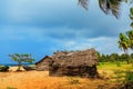 Thatched coconut leaf house or fishing hut on tropical beach Royalty Free Stock Photo