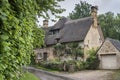 Thatched cottage in the village of Stanton, Cotswolds district of Gloucestershire.  It`s built almost completely of Cotswold stone Royalty Free Stock Photo