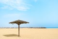 Thatched Parasol on an empty Gold Beach. Dubai Royalty Free Stock Photo
