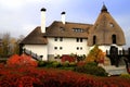 Thatched roof house in autumn. Cottage in rustic style in leaf fall. Rural landscape.Tourism and recreation in countryside Royalty Free Stock Photo