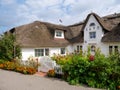 Thatched-roof house with flowers, Nebel, Amrum island, North Frisia, Schleswig-Holstein, Germany Royalty Free Stock Photo