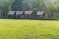 Thatched roof house and a green garden with blue sky in countryside. Royalty Free Stock Photo