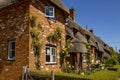 Thatched rose cottages in a Dorset village.