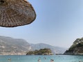 Thatched umbrella by the sea. Summer theme: beach holidays in the sun. Umbrellas on the sandy beach against the background of the Royalty Free Stock Photo