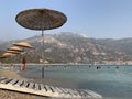 Thatched umbrella by the sea. Summer theme: beach holidays in the sun. Umbrellas on the sandy beach against the background of the Royalty Free Stock Photo