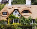 Thatched Village Cottage with Roses Royalty Free Stock Photo