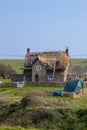 Thatching an old stone house in rural England Royalty Free Stock Photo