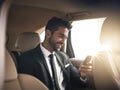 Thats another deal signed and sealed. a handsome young businessman sending a text message while on his morning commute Royalty Free Stock Photo