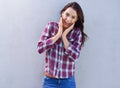 Thats awesome news. an attractive young brunette woman standing against a gray background.