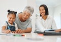 Thats a beautiful flower. a young girl getting help from her mother and grandma while doing her homework at home. Royalty Free Stock Photo