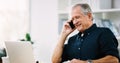 Thats exactly what I wanted to hear. a cheerful mature businessman answering a phone call in his office. Royalty Free Stock Photo