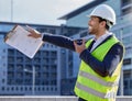 Thats a great spot to start construction. a businessman using his smartphone on a construction site.