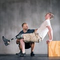 Thats it One more. a physiotherapist helping a young male amputee workout.