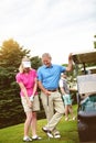 Thats perfect. an affectionate mature couple spending a day on the golf course. Royalty Free Stock Photo