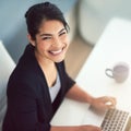 Thats the smile of success. High angle portrait of an attractive young businesswoman working on a laptop in her office. Royalty Free Stock Photo