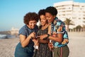 Thats such a great picture of us three. three attractive young women huddled together and looking at a cellphone on the Royalty Free Stock Photo