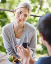 Thats so sweet babe. a beautiful young woman looking uncertain as her boyfriend is proposing. Royalty Free Stock Photo