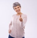 Thats the way to do it. Studio portrait of an mature woman giving thumbs up against a white background. Royalty Free Stock Photo