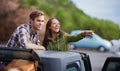 Thats the way. a young couple enjoying themselves on a road tirp.