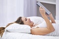 So thats what happened last night...a woman lying on bed while using her laptop. Royalty Free Stock Photo