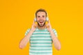 Thats what I call music. Happy guy listen to music yellow background. Handsome man enjoy music playing in headphones