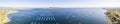 Aerial panorama, Oyster tables on the Thau lagoon and Mont Saint Clair in the background, in Bouzigues, Occitania, France