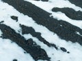 A thawed patch in the snow with black ground spring scenery Royalty Free Stock Photo