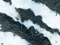 A thawed patch in the snow with black ground spring scenery Royalty Free Stock Photo