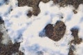 Thawed snow in the shape of a heart, close-up, copy space. Valentine`s day Royalty Free Stock Photo