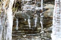 The thawing icicles with the falling water drop in the mountains Royalty Free Stock Photo