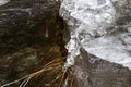 The thawing icicles with the falling water drop in the mountains Royalty Free Stock Photo