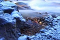 Thawing winter river rocks