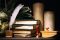 Theater, literature and drama concept. Venetian mask with old inkwell, feather, quill, scrolls, books and seal on wooden table.