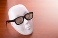 Theater mask in glasses on the table Royalty Free Stock Photo