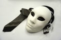 Theater or misogyny concept. Closeup of white classical theatrical mask and men clothing items as a symbol of sexual abuse or