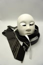 Theater or misogyny concept. Closeup of white classical theatrical mask and men clothing items as a symbol of sexual abuse or