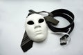 Theater or misogyny concept. Closeup of white classical theatrical mask and men clothing items as a symbol of sexual abuse or