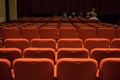 Theater seats and red chairs inside