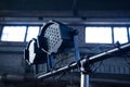 Theater spotlights on black industrial room with windows. Royalty Free Stock Photo