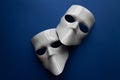 Theatre concept with the white masks on classic blue background. Anonimous, Incognito, Conspiracy concept. Place for