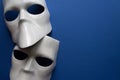 Theatre concept with the white masks on classic blue background. Anonimous, Incognito, Conspiracy concept. Place for