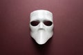 Theatre concept with the white masks on trendy vinous bordeaux, burgundy background. Anonimous, Incognito, Conspiracy