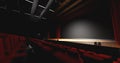 Theatre with empty stage in spotlight. Red theater curtain and seats Royalty Free Stock Photo