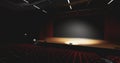 Theatre with empty stage in spotlight. Red theater curtain and seats Royalty Free Stock Photo