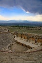 Looking towards the stage of the theatre, Hierapolis with dark storm clouds on the horizon