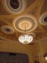 Theatrical interior. Beautiful, large crystal chandelier in a classic style. Chandelier on the ceiling in the theater.